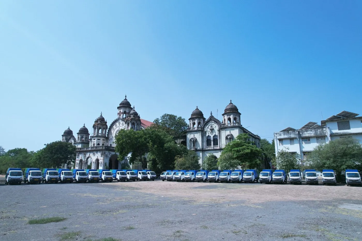 The collection fleet lined up in front of a heritage municipal building