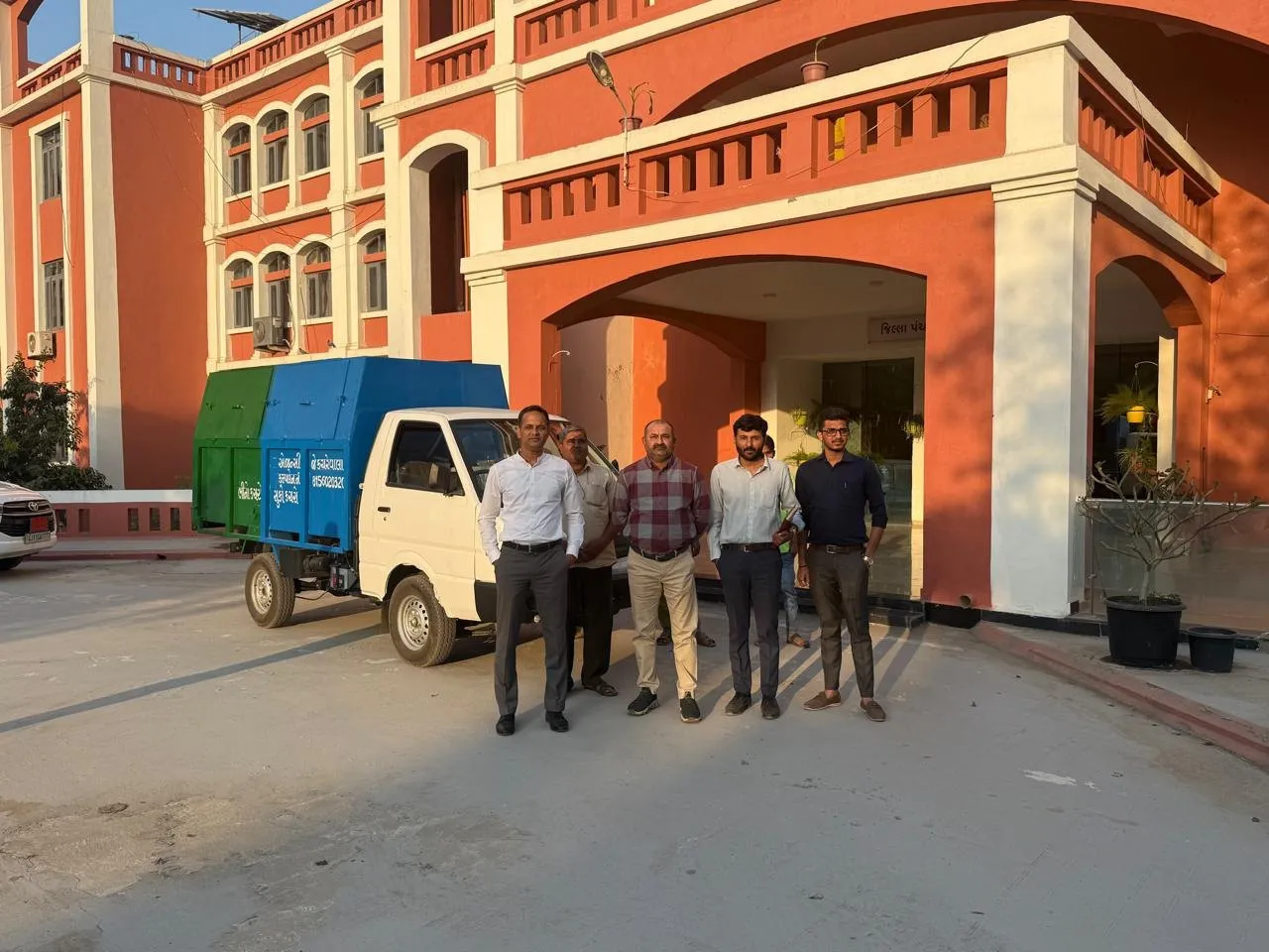 The J Kachrewala team with a collection vehicle outside a municipal office in Gujarat